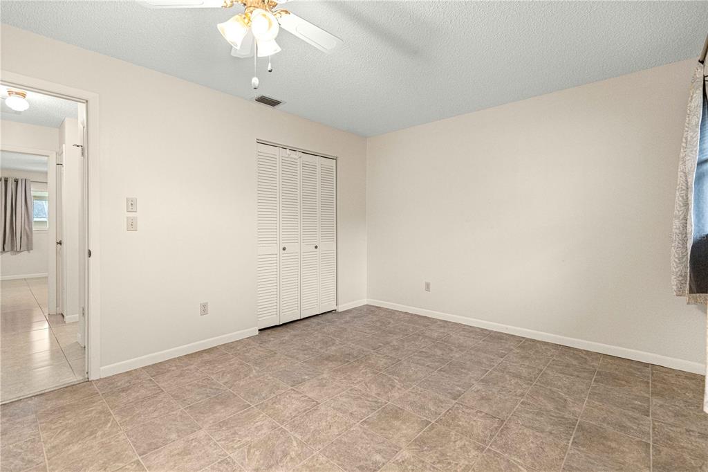 8665 Southwest 94 Street, Unit C Ocala, FL 34481 - Photo 17 of 29 an empty room with a chandelier fan