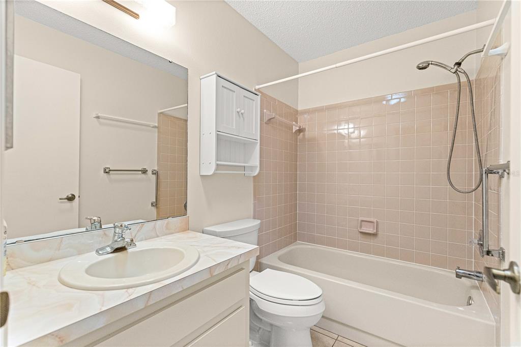 8665 Southwest 94 Street, Unit C Ocala, FL 34481 - Photo 19 of 29 a bathroom with a sink toilet and shower