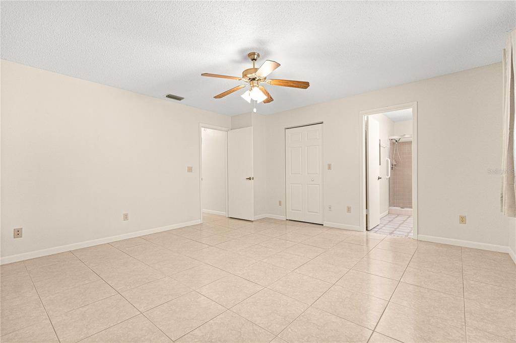 8665 Southwest 94 Street, Unit C Ocala, FL 34481 - Photo 22 of 29 an empty room with closet and fan