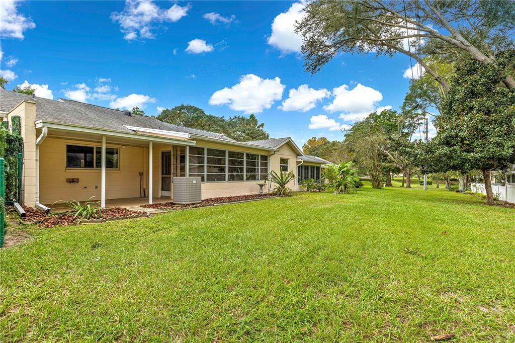 8665 Southwest 94 Street, Unit C Ocala, FL 34481 - Photo 26 of 29 a view of a house with a big yard