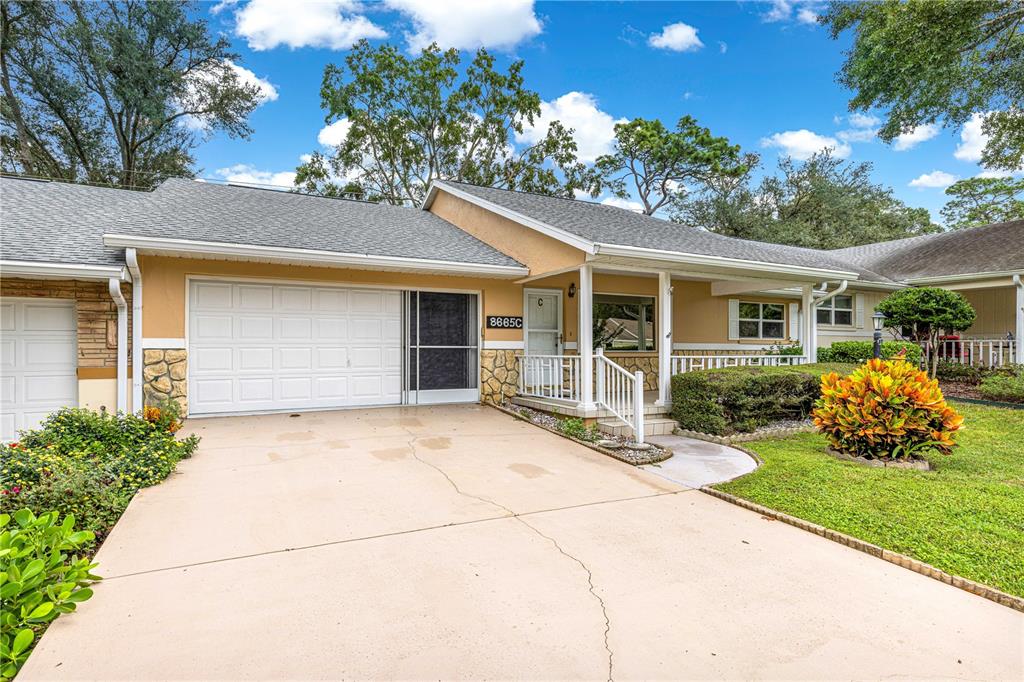 8665 Southwest 94 Street, Unit C Ocala, FL 34481 - Photo 27 of 29 a front view of a house with garden