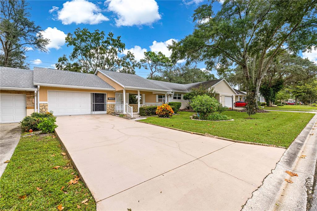 8665 Southwest 94 Street, Unit C Ocala, FL 34481 - Photo 28 of 29 a view of house with garden