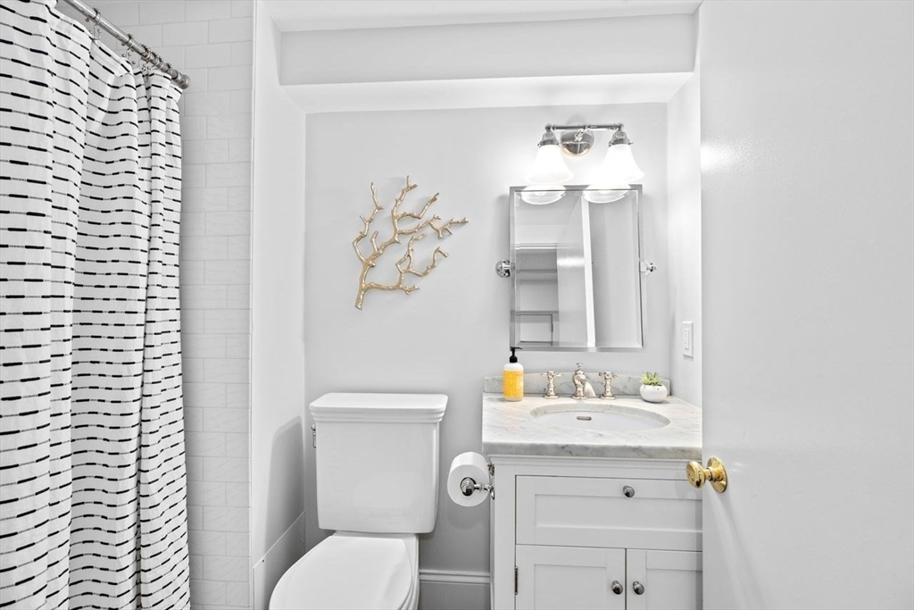 44 Montvale Road Newton, MA 02459 - Photo 25 of 37 a bathroom with a sink a toilet and mirror