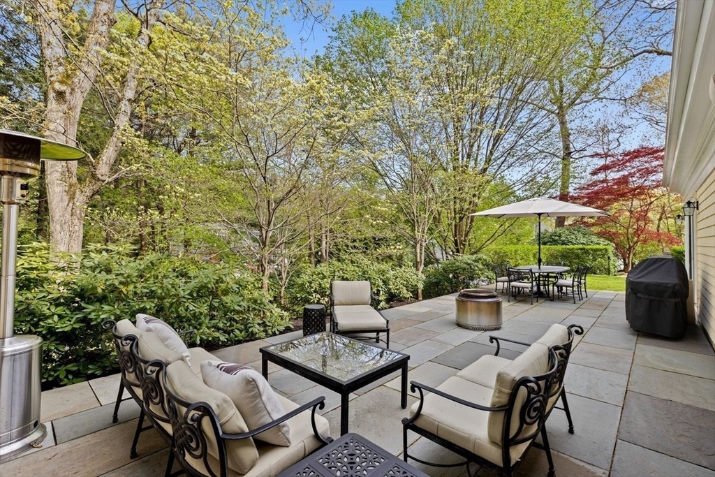 44 Montvale Road Newton, MA 02459 - Photo 33 of 37 a view of a patio with a table and chairs under an umbrella