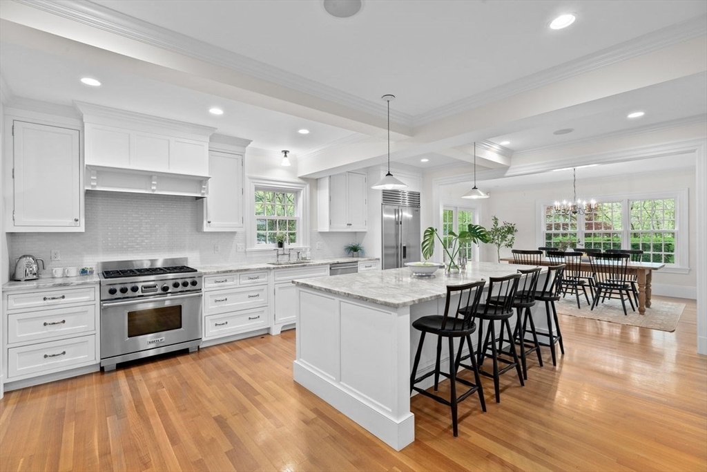 44 Montvale Road Newton, MA 02459 - Photo 4 of 37 a kitchen with stainless steel appliances a stove a sink a center island and wooden floor