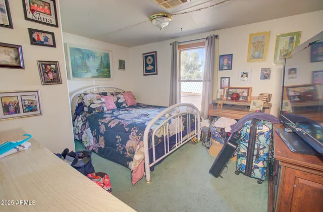 a bedroom with bed and a large window