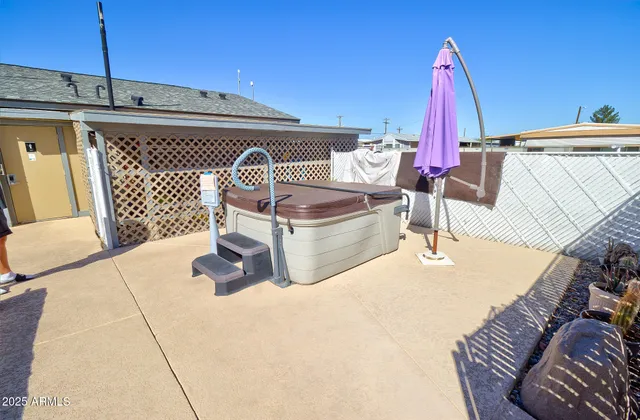 a view of roof deck with couch and chairs