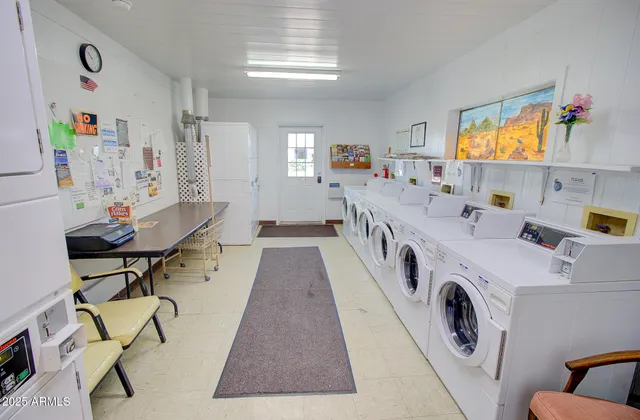 a view of a kitchen filled with furniture and clutter