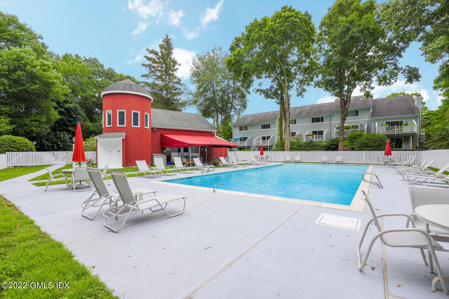 63 Stirrup Lane, Unit 63 Riverside, CT 06878 - Photo 3 of 21 a park view with a bench plants and large trees