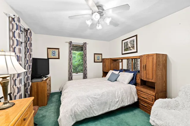 a living room with furniture a fireplace and a large window
