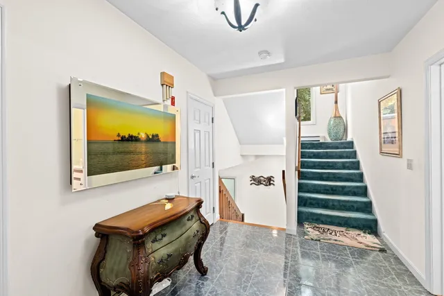 a view of entryway with stairs and wooden floor