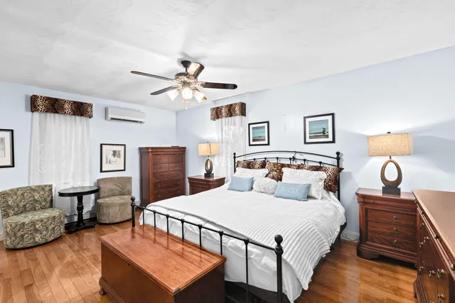 a living room with furniture flat screen tv and a large window