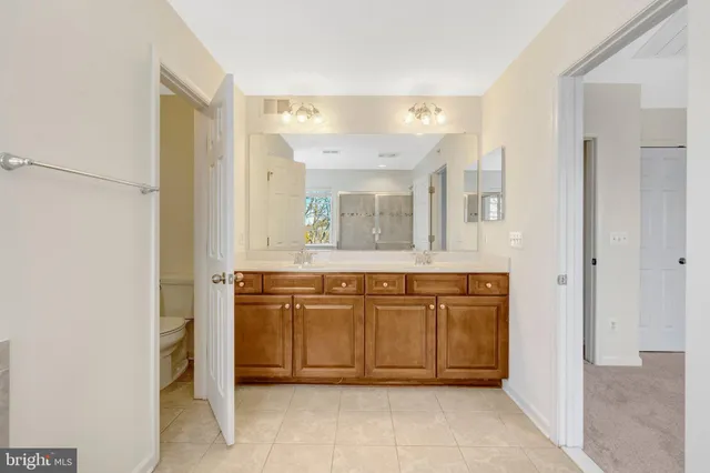 a spacious bathroom with a granite countertop sink mirror and a