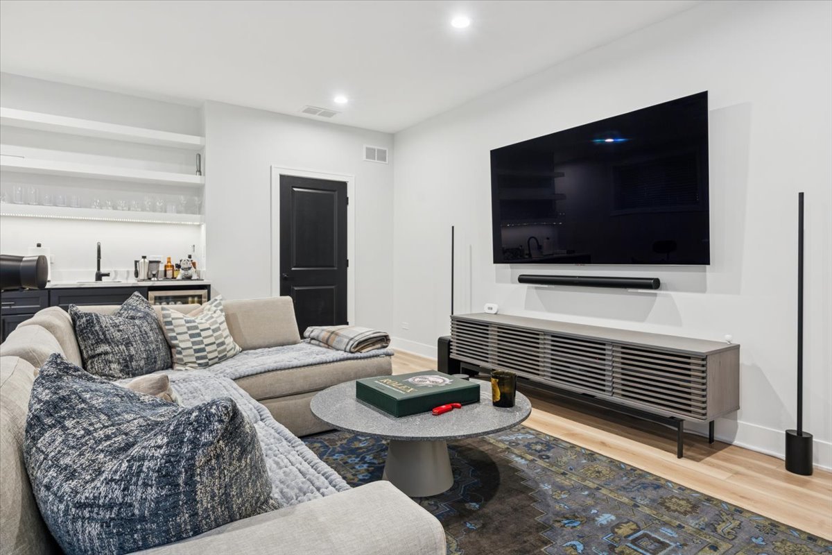 Undisclosed Address Chicago, IL 60630 - Photo 12 of 26 a living room with furniture and a flat screen tv