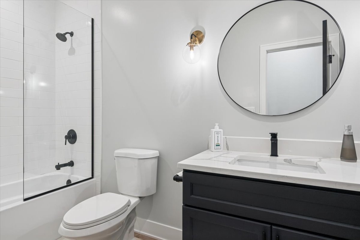 Undisclosed Address Chicago, IL 60630 - Photo 15 of 26 a bathroom with a sink a toilet and a mirror