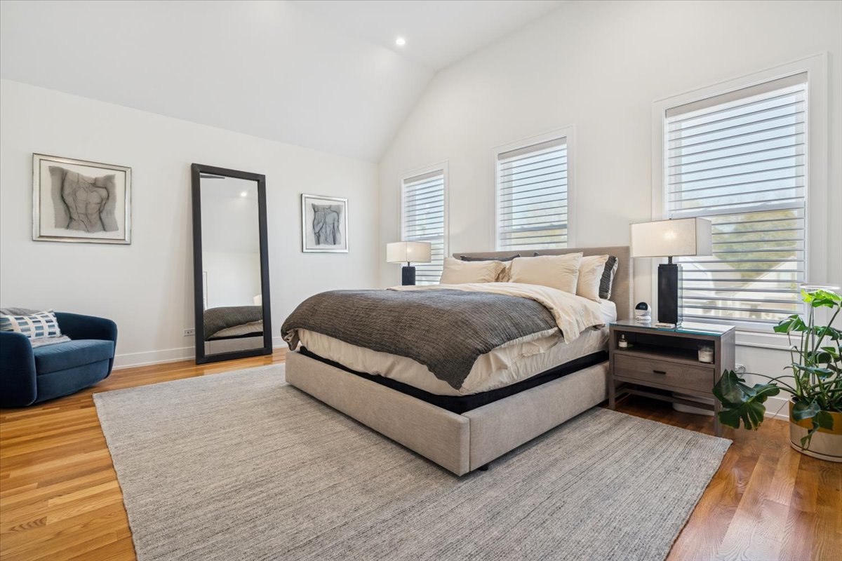 Undisclosed Address Chicago, IL 60630 - Photo 17 of 26 a bedroom with a bed and wooden floor