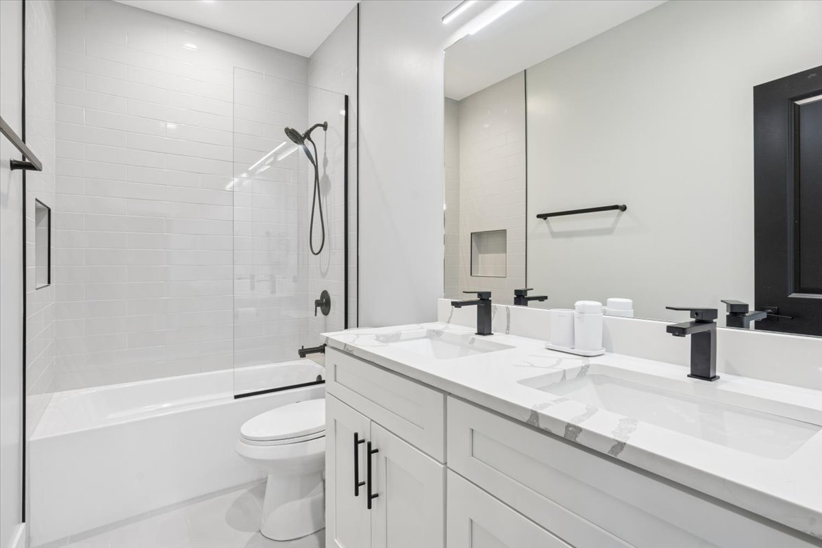 Undisclosed Address Chicago, IL 60630 - Photo 20 of 26 a bathroom with a granite countertop sink a toilet and shower