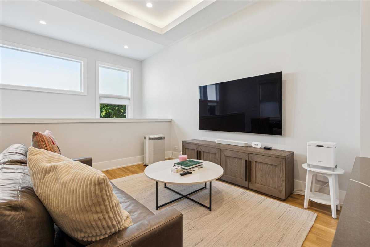 Undisclosed Address Chicago, IL 60630 - Photo 9 of 26 a living room with furniture and a flat screen tv