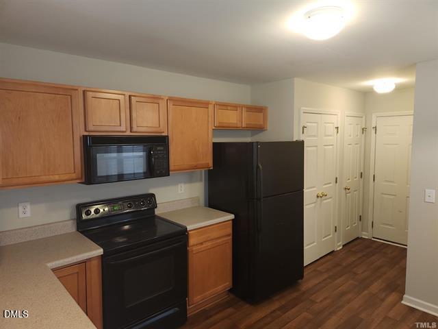 2630 Vega Court Raleigh, NC 27614 - Photo 8 of 17 a kitchen with a refrigerator stove and wooden cabinets