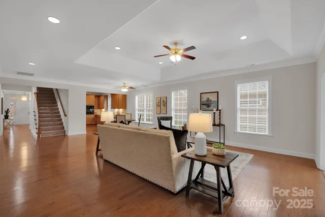 a living room with furniture and wooden floor