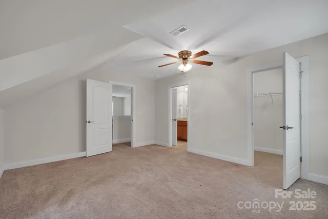 a view of an empty room with a ceiling fan