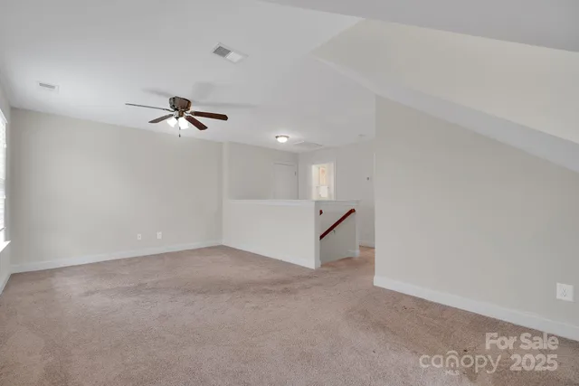 a view of a livingroom with a ceiling fan and window