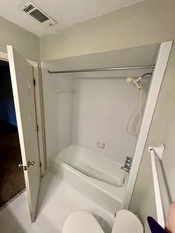 a bathroom with a tub and shower