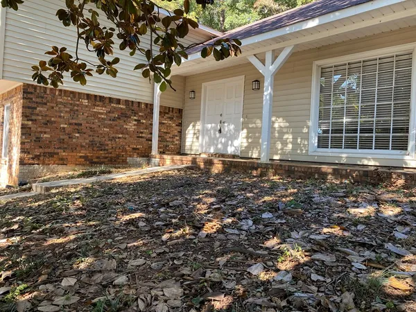 a view of a house with a tree