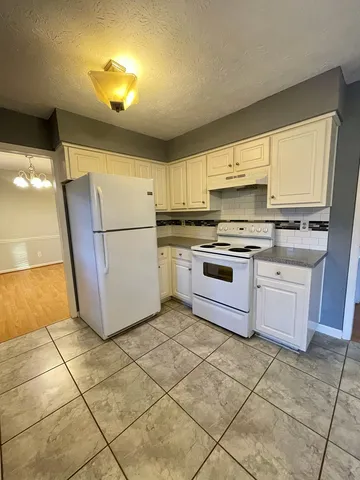 a kitchen with a stove a refrigerator and a sink