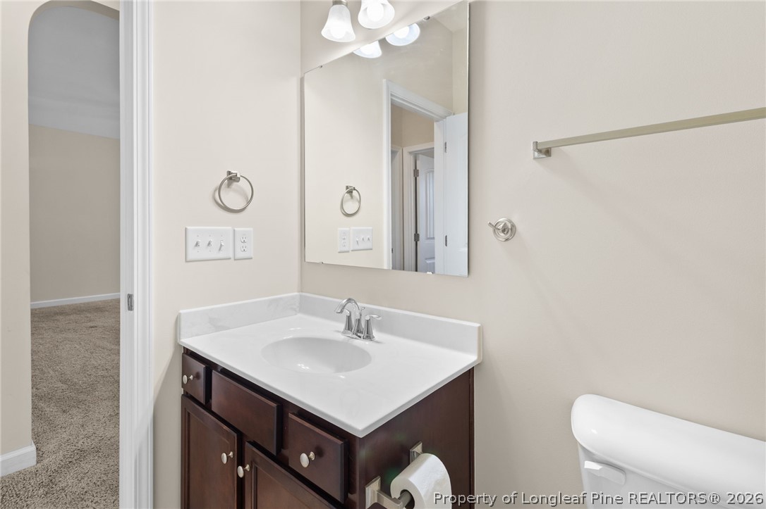 216 Meherrin Loop Raeford, NC 28376 - Photo 26 of 38 a bathroom with a sink toilet and mirror
