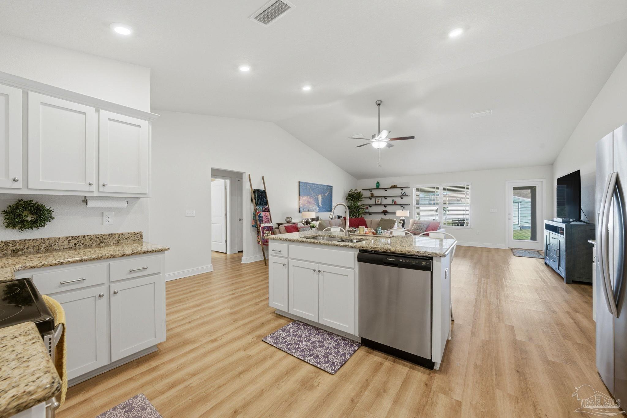 6022 Willsey Trail Crestview, FL 32539 - Photo 12 of 33 a kitchen with stainless steel appliances granite countertop a sink cabinets and wooden floor
