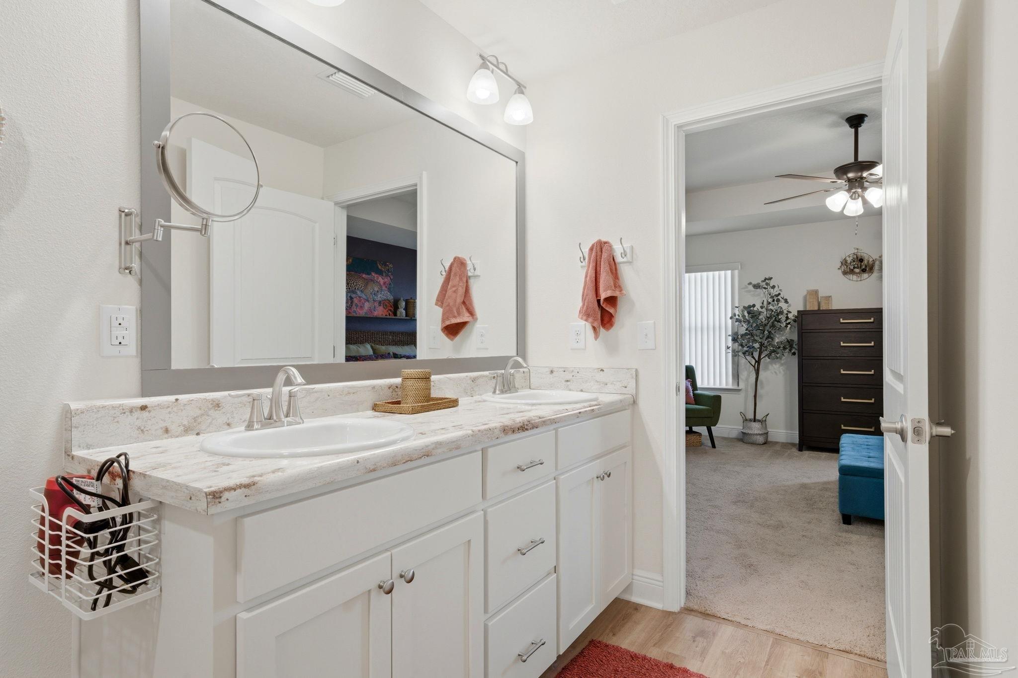6022 Willsey Trail Crestview, FL 32539 - Photo 22 of 33 a spacious bathroom with a granite countertop sink and a mirror
