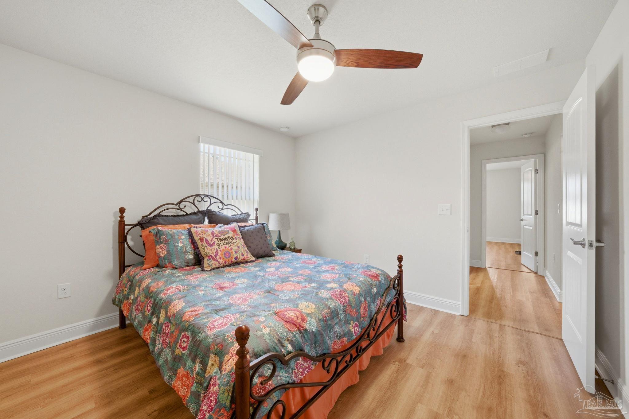 6022 Willsey Trail Crestview, FL 32539 - Photo 26 of 33 a bedroom with a bed and wooden floor