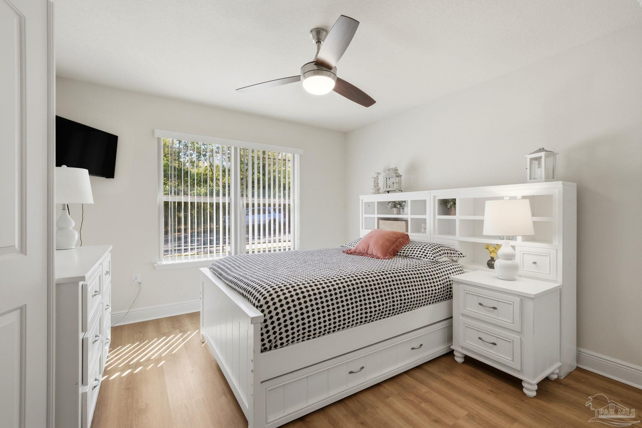 6022 Willsey Trail Crestview, FL 32539 - Photo 27 of 33 a bedroom with a bed and a flat tv screen on dresser