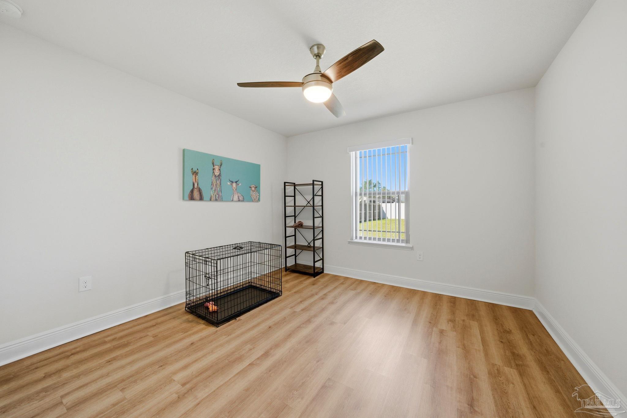 6022 Willsey Trail Crestview, FL 32539 - Photo 30 of 33 a view of room with hardwood floor and ceiling fan