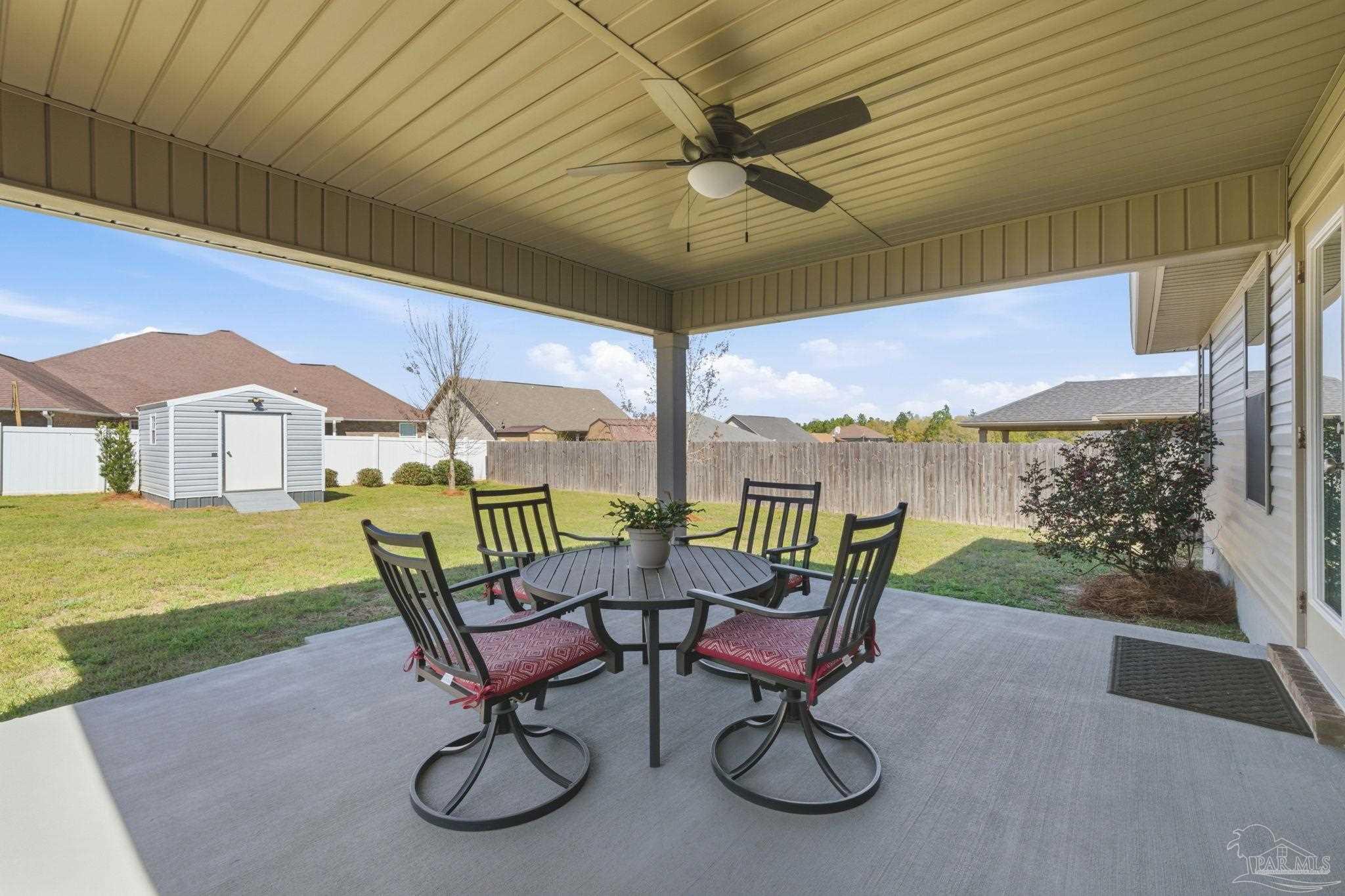 6022 Willsey Trail Crestview, FL 32539 - Photo 33 of 33 a view of a patio with a table chairs and a swimming pool