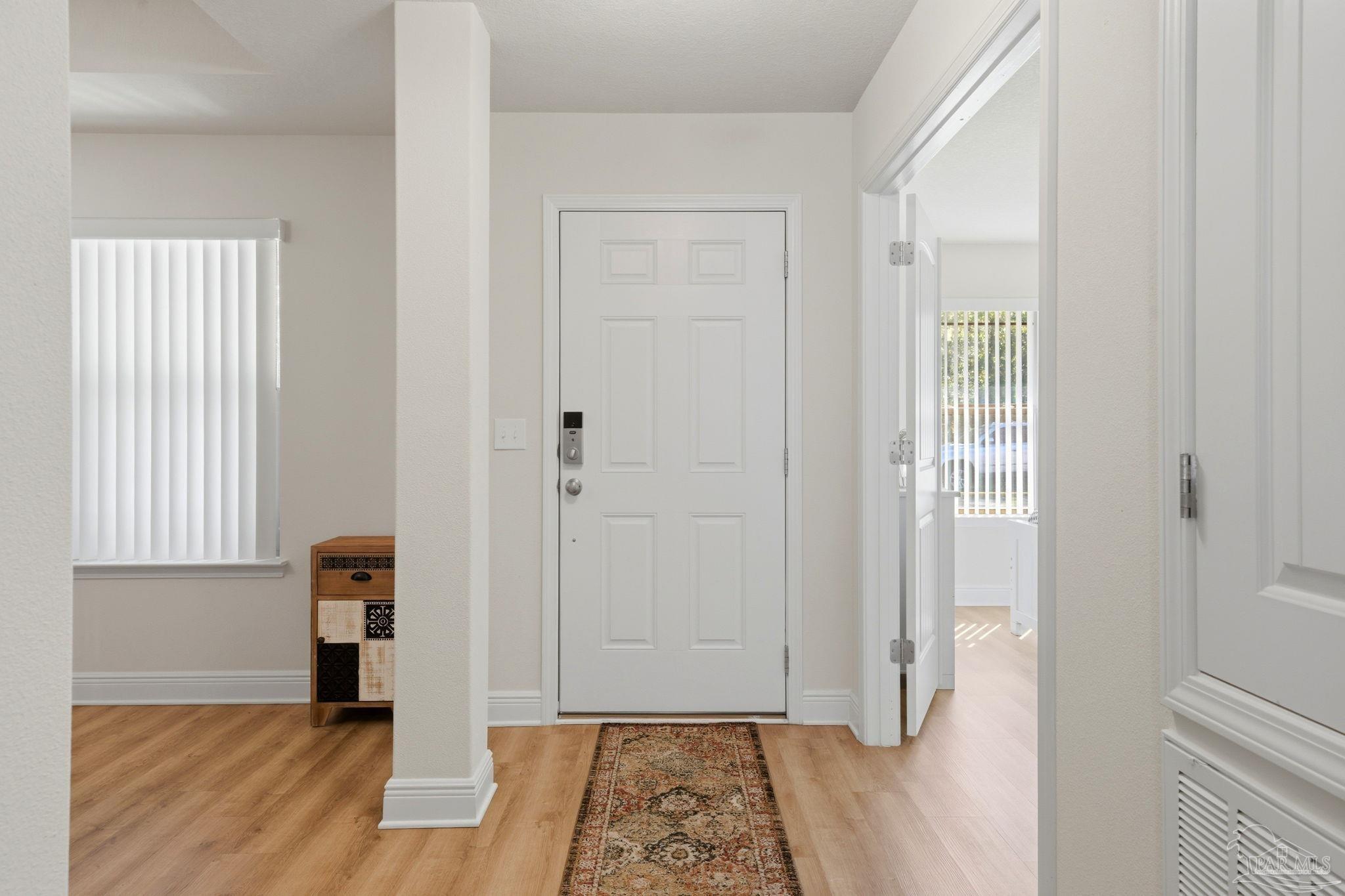 6022 Willsey Trail Crestview, FL 32539 - Photo 5 of 33 a view of a hallway with wooden floor and closet