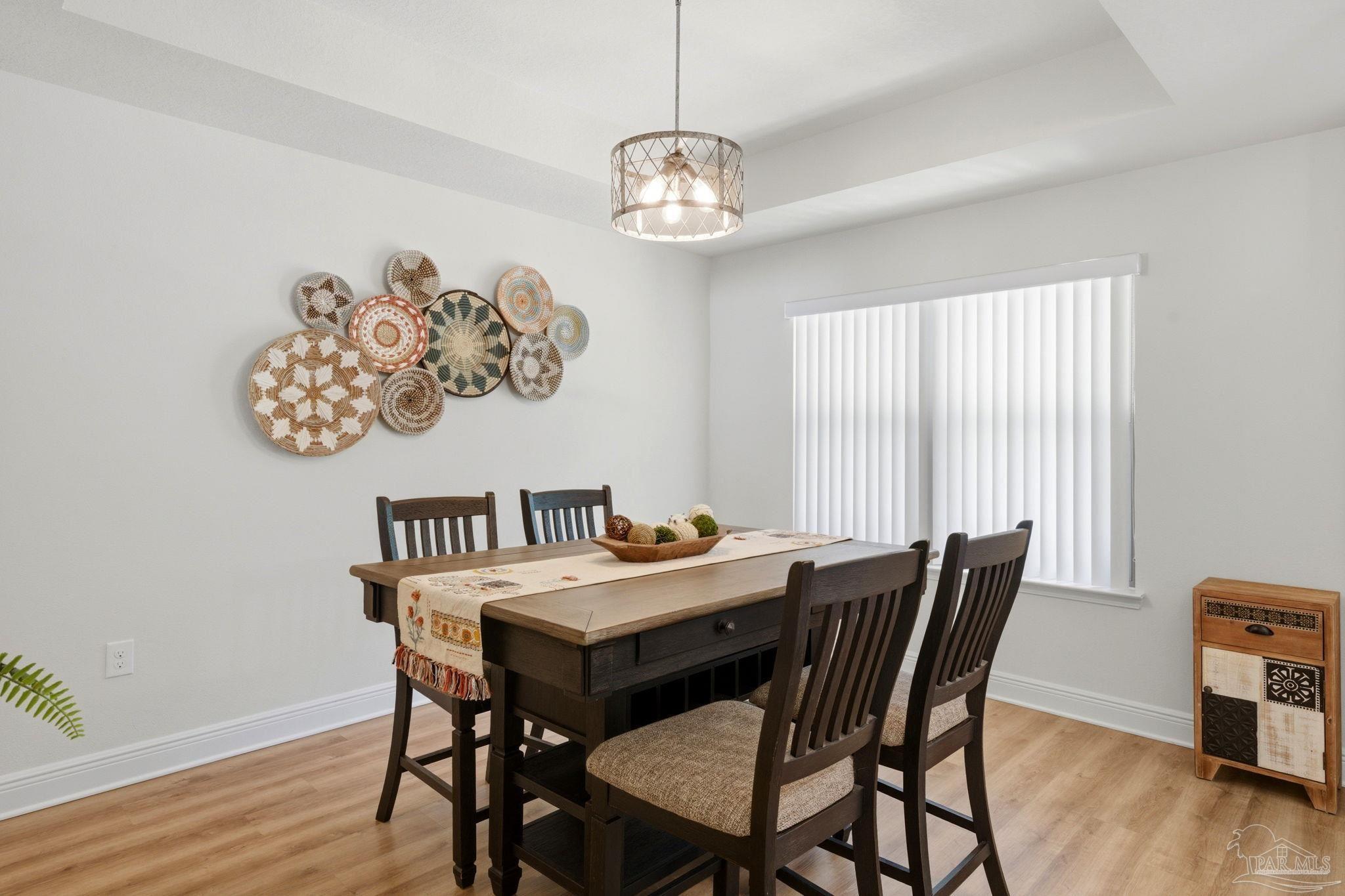 6022 Willsey Trail Crestview, FL 32539 - Photo 6 of 33 a view of a dining room with furniture window and wooden floor