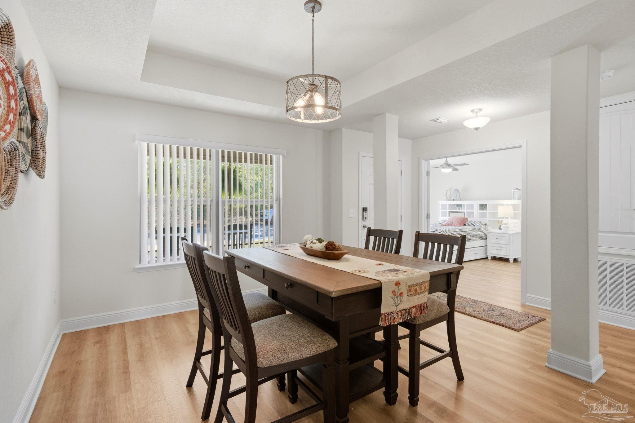 6022 Willsey Trail Crestview, FL 32539 - Photo 7 of 33 a view of a dining room with furniture window and wooden floor