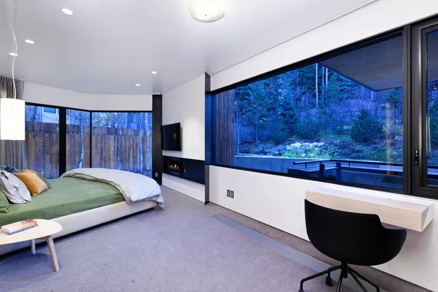 a bathroom with a glass door shower and a yard