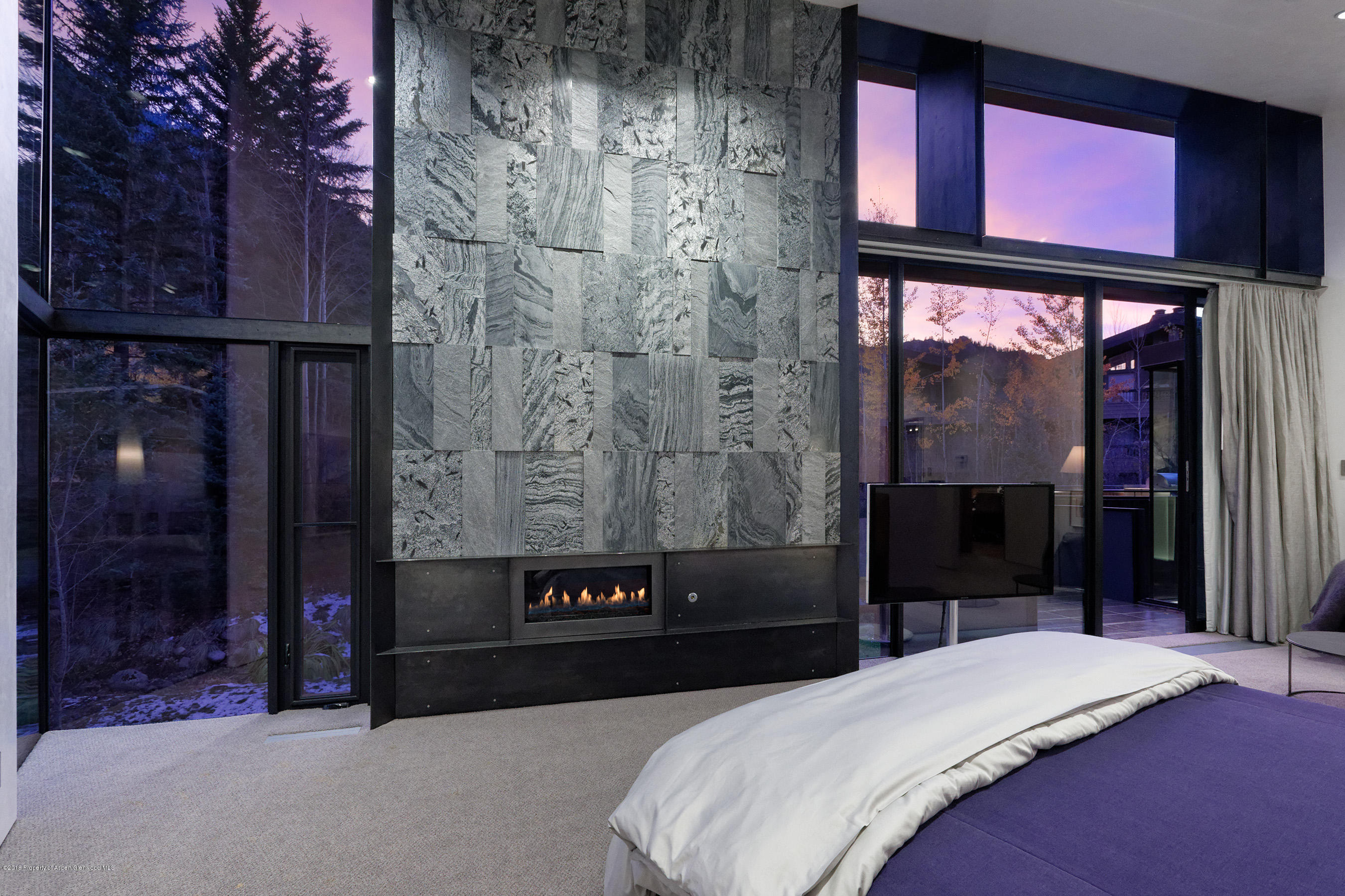 1118 Waters Avenue Aspen, CO 81611 - Photo 18 of 30 a bedroom with a bed and a window