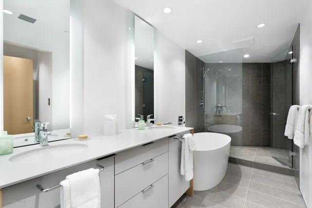 a bathroom with a double vanity sink mirror and toilet