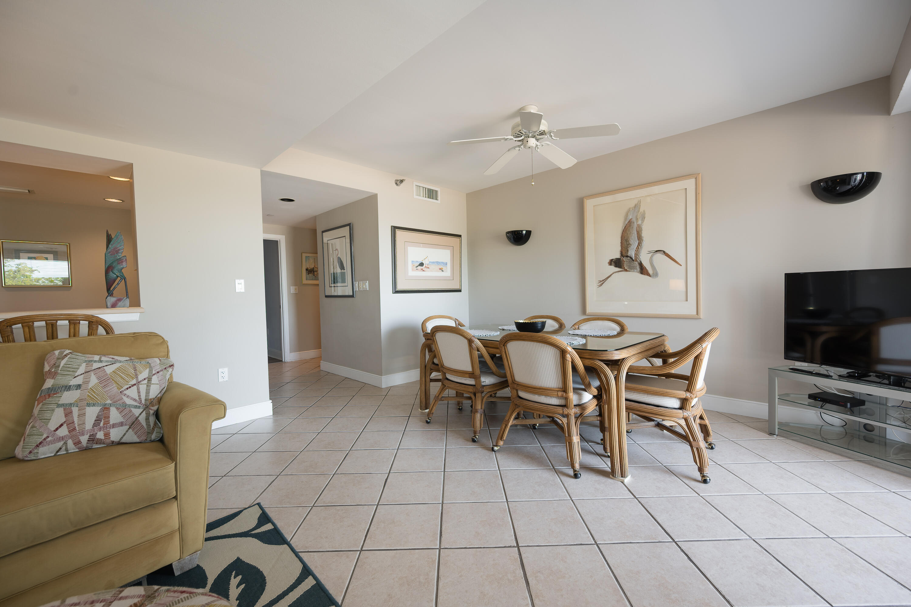 105 Front Street, Unit 119 Key West, FL 33040 - Photo 12 of 18 a living room with furniture and a flat screen tv