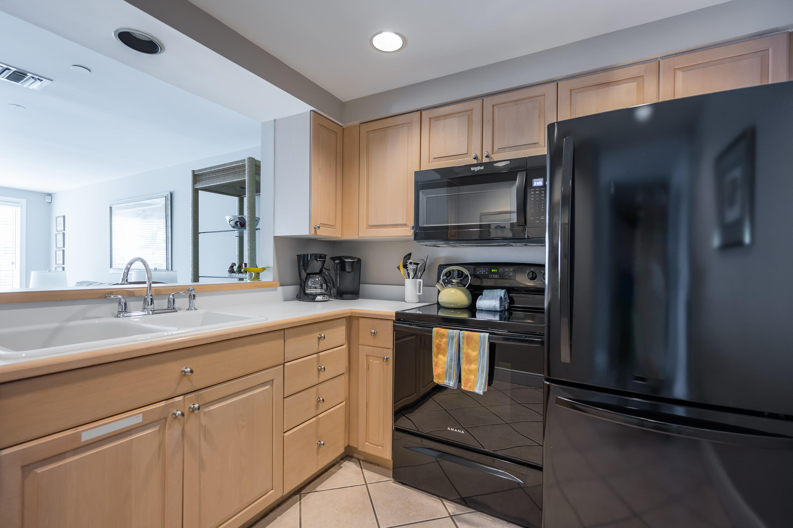 105 Front Street, Unit 119 Key West, FL 33040 - Photo 5 of 18 a kitchen with stainless steel appliances granite countertop a refrigerator and a stove top oven