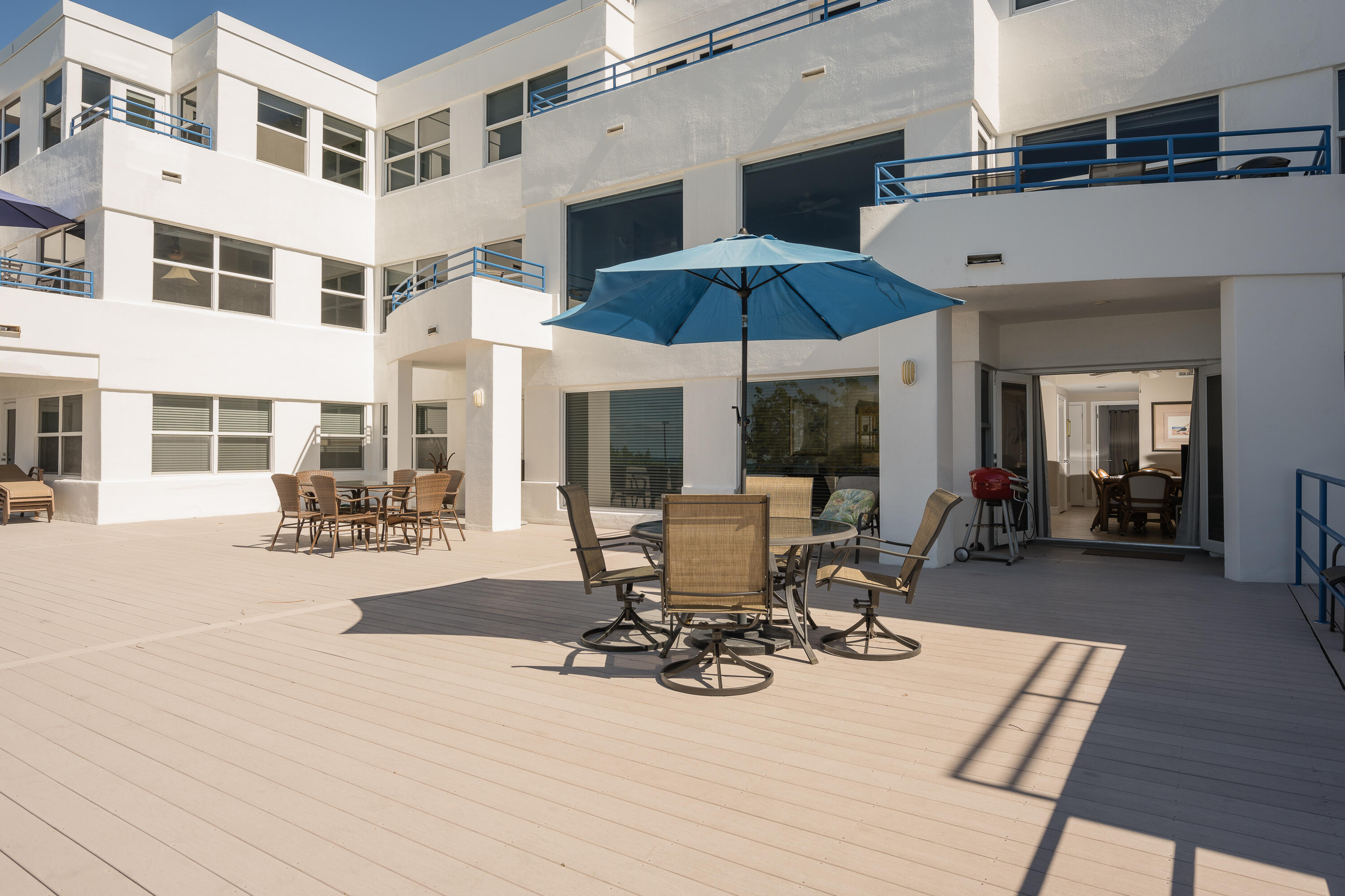 105 Front Street, Unit 119 Key West, FL 33040 - Photo 9 of 18 a view of a patio with table and chairs under an umbrella
