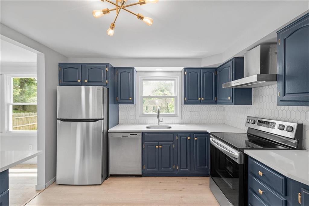 457 Inwood Road Pittsburgh, PA 15237 - Photo 18 of 39 a kitchen with a sink a refrigerator and cabinets