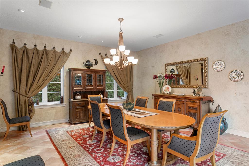 4803 West Woodmere Road Tampa, FL 33609 - Photo 20 of 80 a dining room with furniture a rug and a chandelier