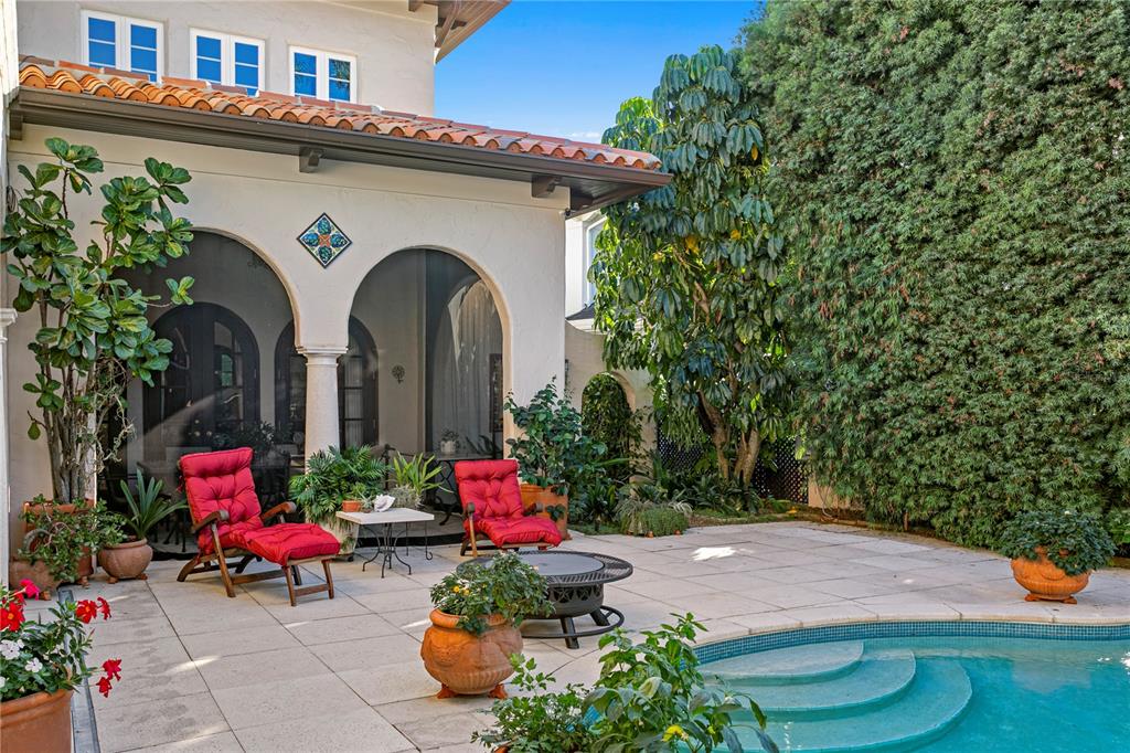 4803 West Woodmere Road Tampa, FL 33609 - Photo 57 of 80 a front view of a house with chairs and plants