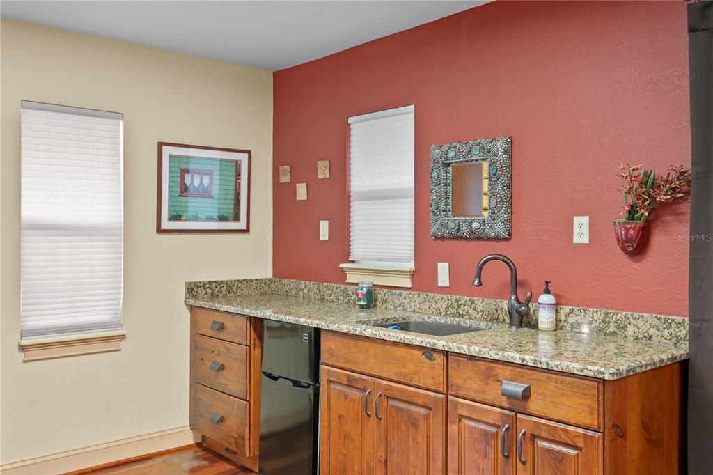 4803 West Woodmere Road Tampa, FL 33609 - Photo 66 of 80 a bathroom with a granite countertop sink a mirror and vanity