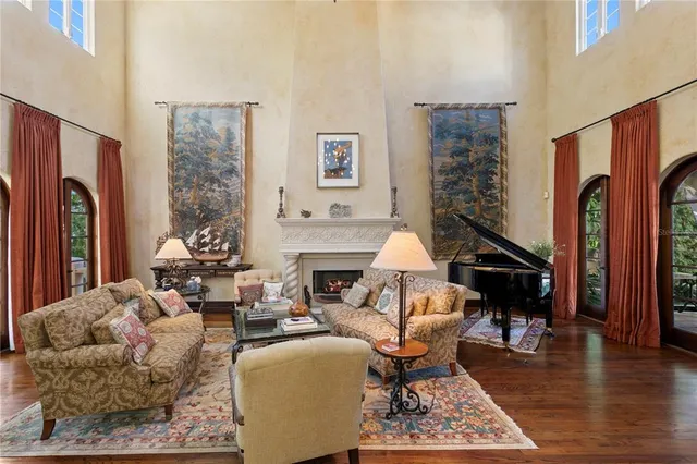 a dining room with furniture a rug and a chandelier
